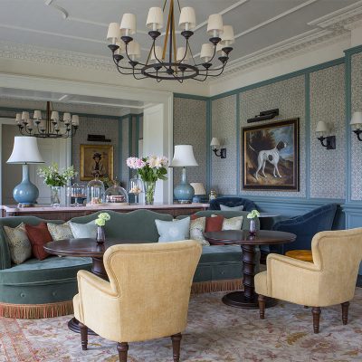 Brightly decorated lounge with green and yellow sofas