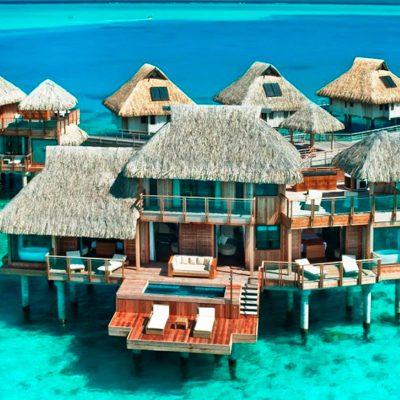 A selection of luxury hotel rooms supported on pillars jetting out into the ocean at the Laucala Island Resort – Fiji.