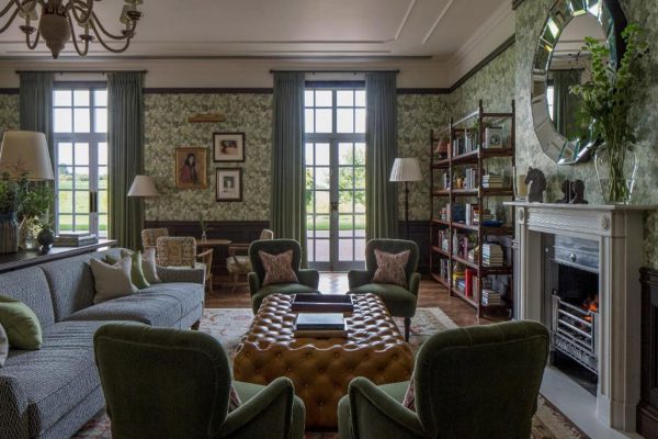 Green floral decor lounge with sofas and books in the Four Seasons Hotel, Hampshire